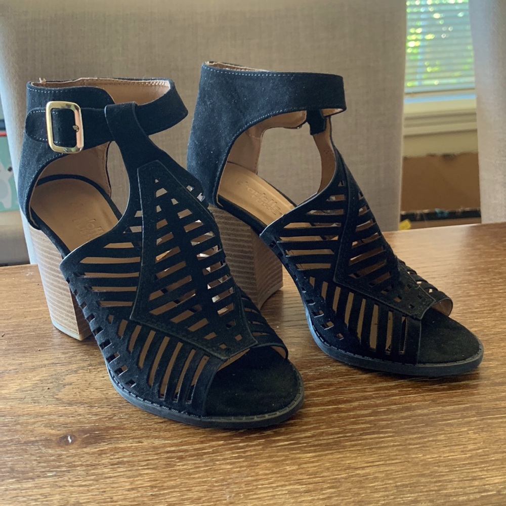 Laser cutout black heeled sandals. Never worn, with stickers still present.